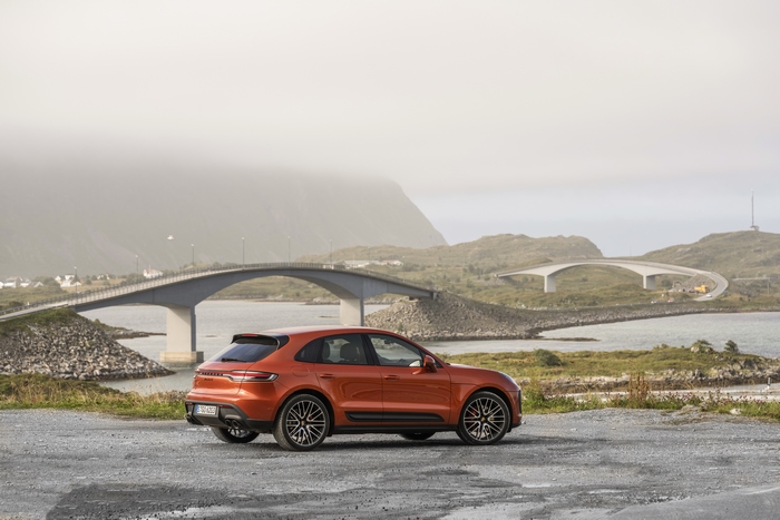 Orange Porsche Macan S by scenic coastal bridges