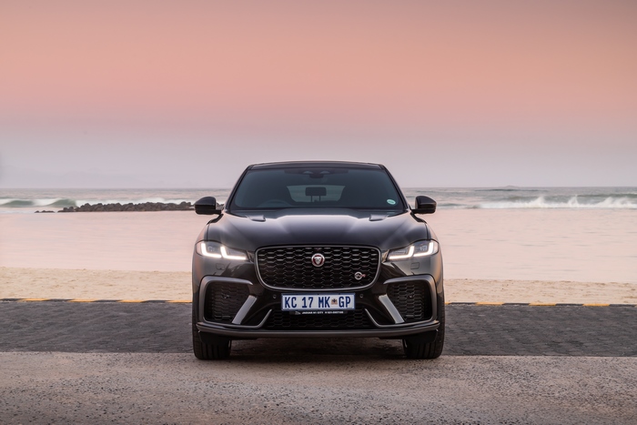 Black Jaguar F-Pace SVR SUV at sunset beach