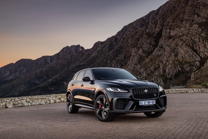 Black Jaguar F-Pace SVR SUV in mountains at sunset
