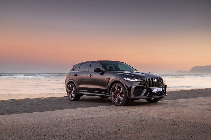 2021 Black Jaguar F-Pace SVR SUV by the ocean at sunset