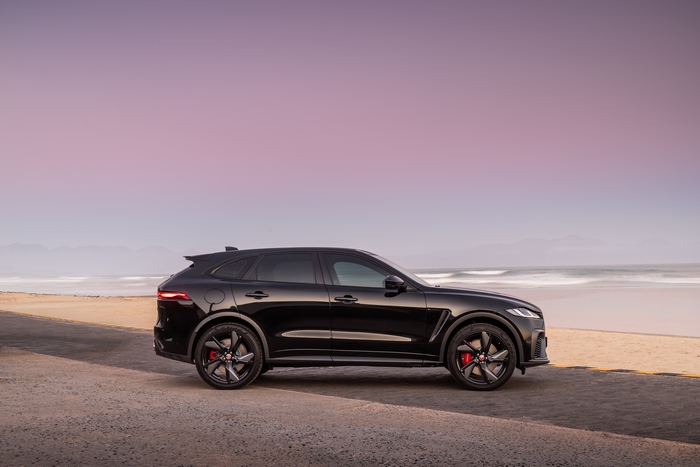 Black Jaguar F-Pace SVR SUV on beach at sunset