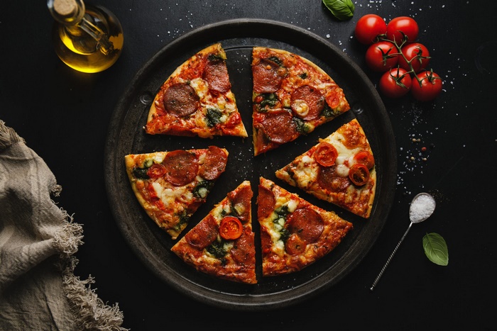 Rustic Still Life: Pepperoni Pizza Slices with Fresh Ingredients
