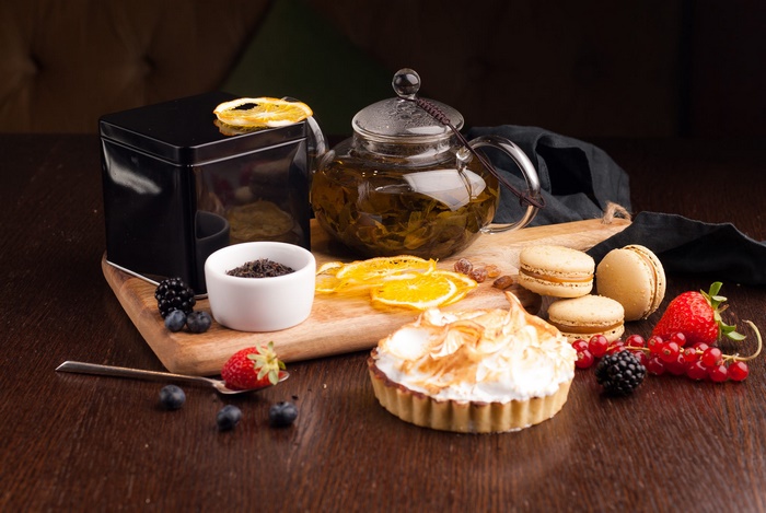 Still Life with Tea, Meringue Tartlet, and Macarons