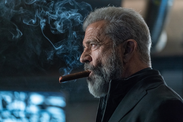 Mel Gibson smoking a cigar in Boss Level