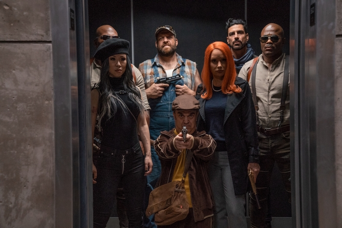 Boss Level cast armed in an elevator