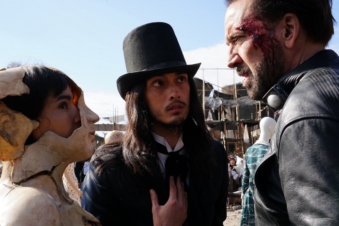 Nicolas Cage, man in top hat, and masked figure in Ghostland