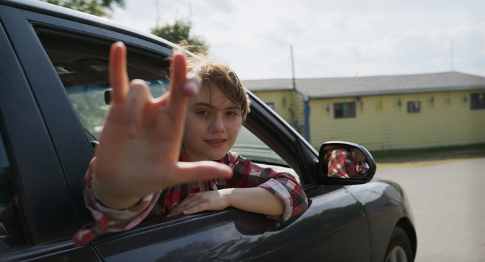 Emilia Jones in CODA making ASL 'I love you' sign