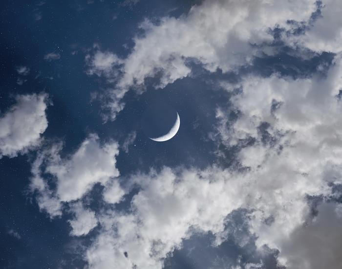 Crescent Moon and Clouds in Dark Sky