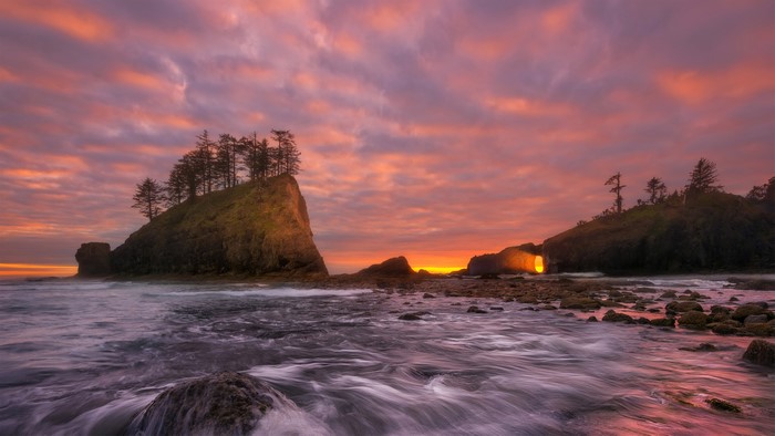 Olympic Coast sunset with glowing sea arch and vibrant sky