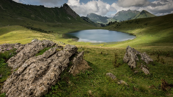 Green Mountain Landscape with Lake and Rocks