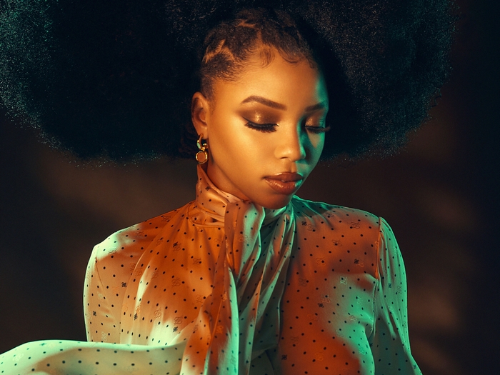 Chloe Bailey with afro and artistic lighting