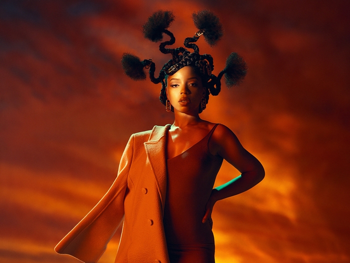 Chloe Bailey striking a pose in warm tones