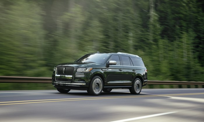 Dark Green Lincoln Navigator Black Label SUV driving