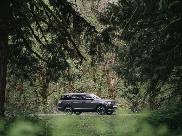 2022 Lincoln Navigator Black Label SUV in a lush forest