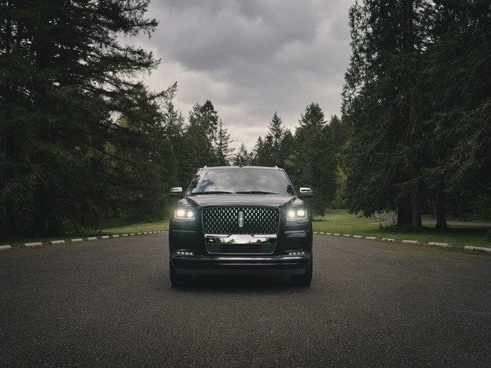 Lincoln Navigator Black Label SUV on a tree-lined road