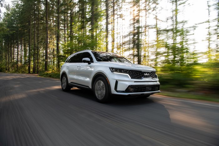 2022 White Kia Sorento PHEV driving through forest