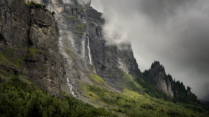 4K Mountain Cliff with Waterfall and Misty Clouds