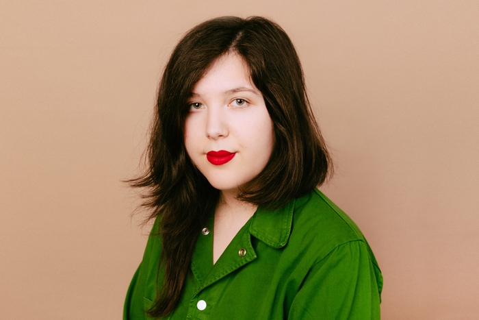 Lucy Dacus in green shirt and red lipstick