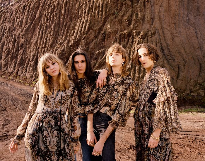 Maneskin band members in patterned outfits outdoors
