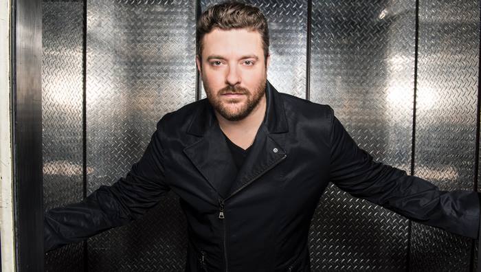 Chris Young in black jacket against metal background