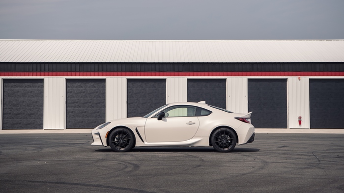 Toyota GR 86 sport car parked in front of garages