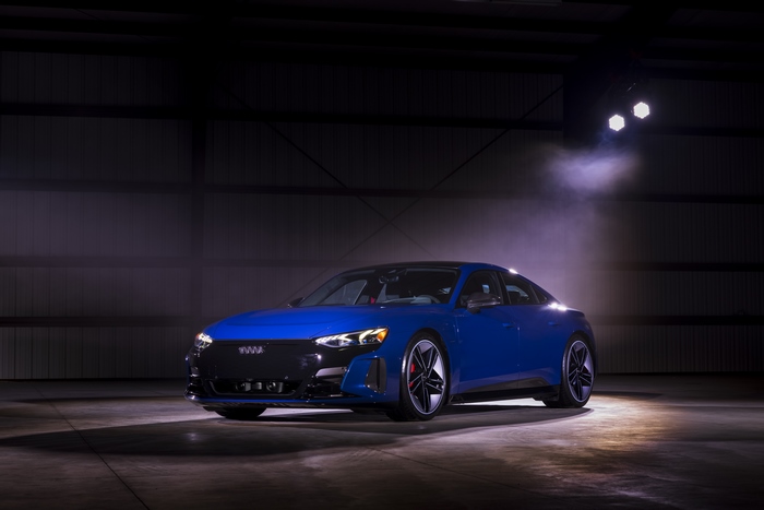 Blue Audi e-tron GT Quattro electric car under spotlights