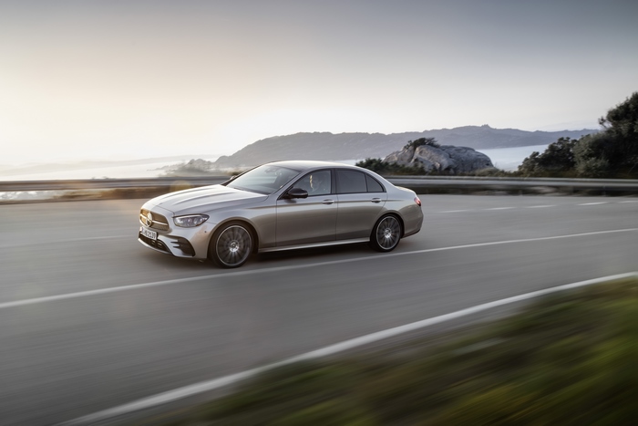 Silver Mercedes-Benz E 450 4MATIC AMG Line driving at sunset