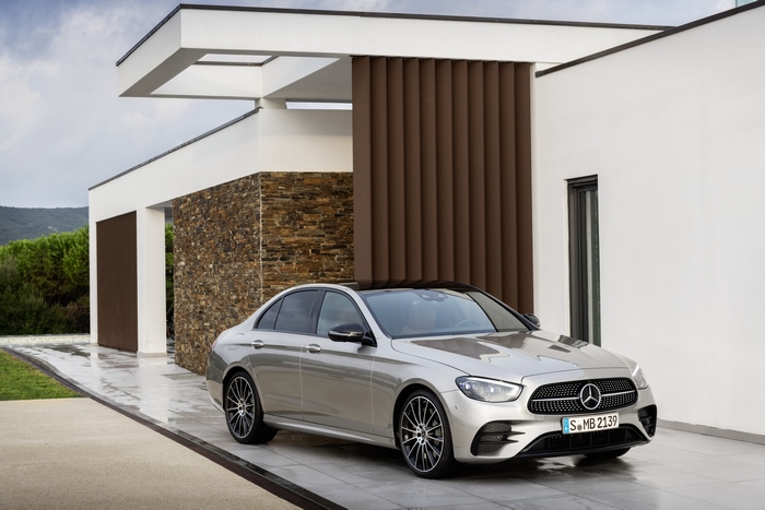 Silver Mercedes-Benz E 450 AMG Line sedan at modern house