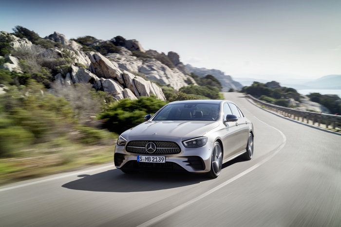 Silver Mercedes-Benz E 450 on a scenic mountain road