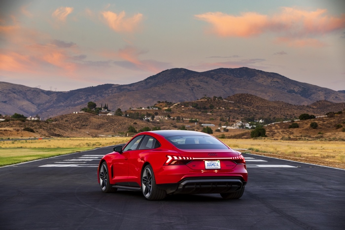 Red Audi RS e-tron GT electric car at sunset