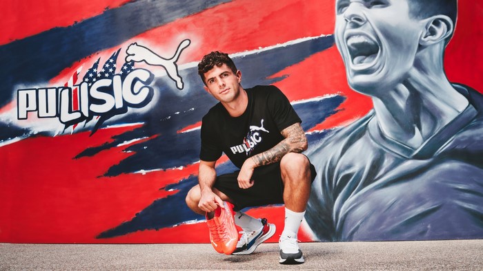 Christian Pulisic with Puma soccer cleats and mural