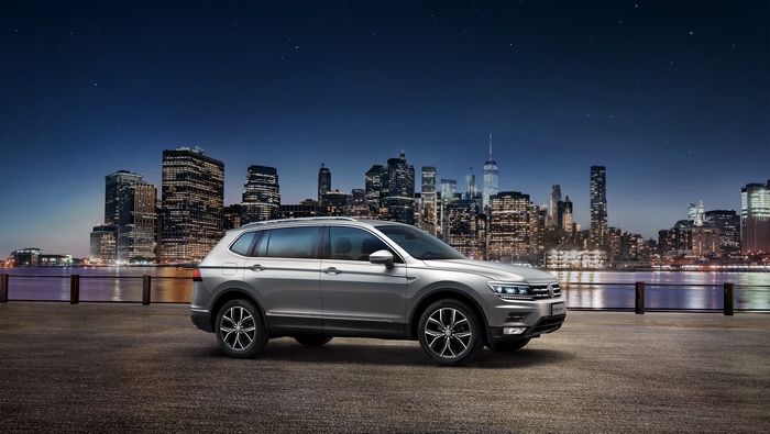 Volkswagen Tiguan L SUV with city skyline at night