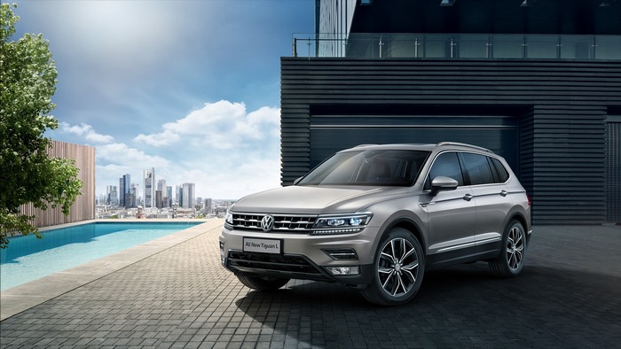 Silver Volkswagen Tiguan L SUV by a pool with city view