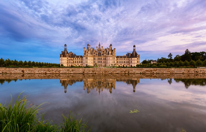 Majestic Château de Chambord reflection at dusk, France