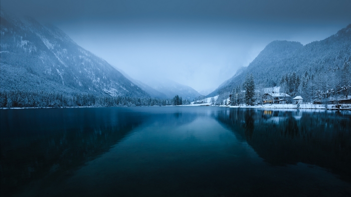 Serene Winter Lake Reflecting Snowy Mountains
