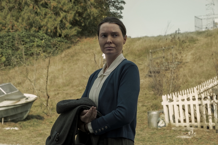 Samantha Sloyan in Midnight Mass holding a coat