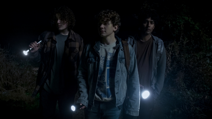 Midnight Mass: Three boys with flashlights at night