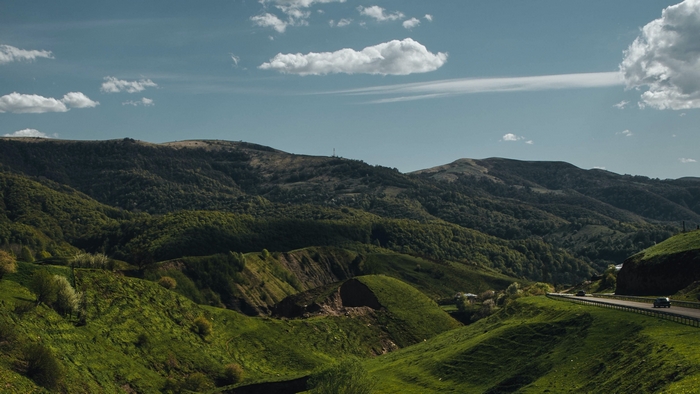 Lush green mountains and winding road