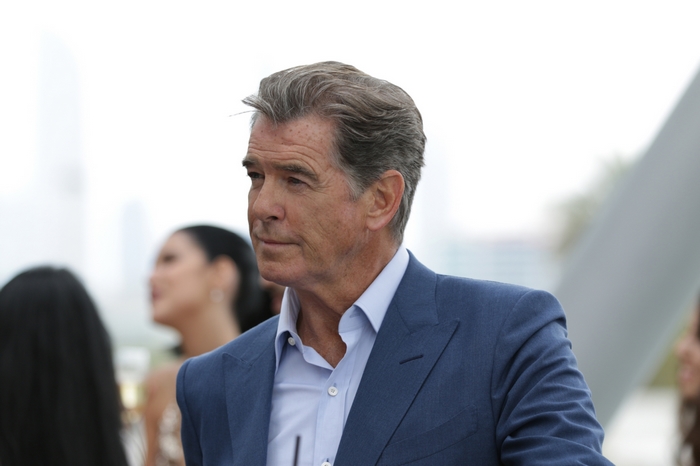 Pierce Brosnan in a blue suit outdoors