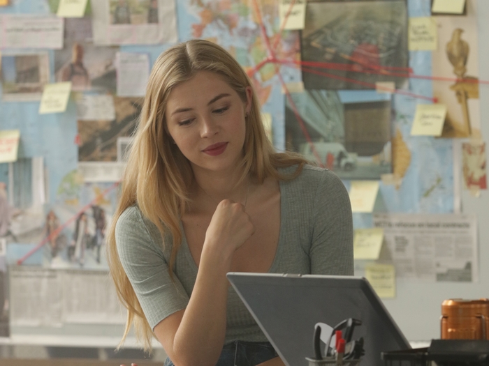 Hermione Corfield focused at desk in The Misfits