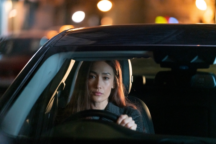 Maggie Q driving at night in The Protégé