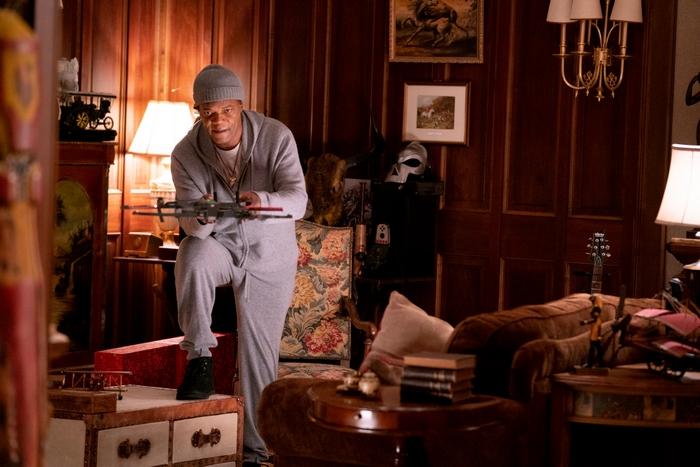 Samuel L. Jackson holding a crossbow in The Protégé