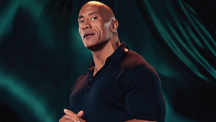 Dwayne Johnson looking confident in a dark polo