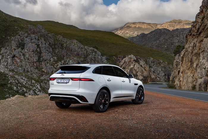 White Jaguar F-Pace SUV on a scenic mountain road