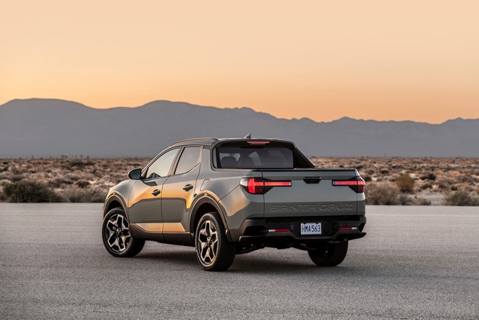 Hyundai Santa Cruz pickup parked in desert at sunset.