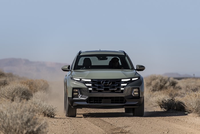 Hyundai Santa Cruz pickup driving on dusty desert road