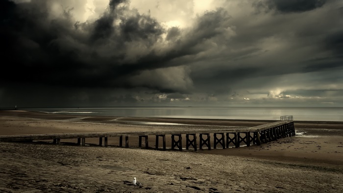 Dramatic Sky Over Pier and Beach