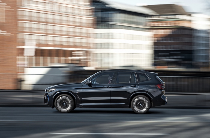 Black BMW iX3 M Sport Electric SUV driving in city