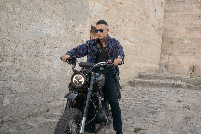 No Time To Die: Man on motorcycle with rifle