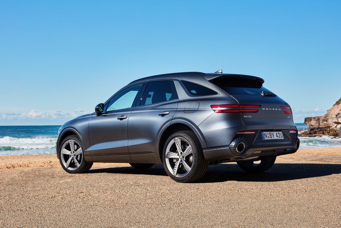 Grey Genesis GV70 SUV parked on a beach
